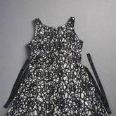 Black lace dress on a tiled floor
